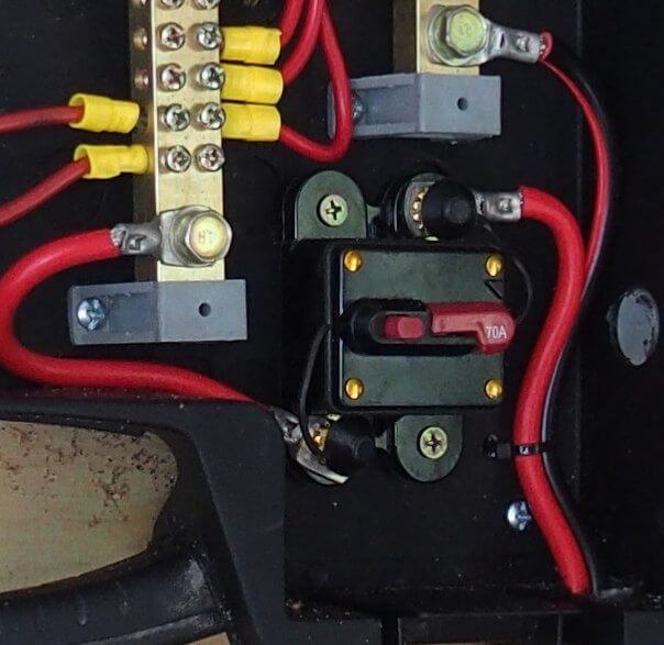 Close-up of electrical connections with red and black wires and connectors.