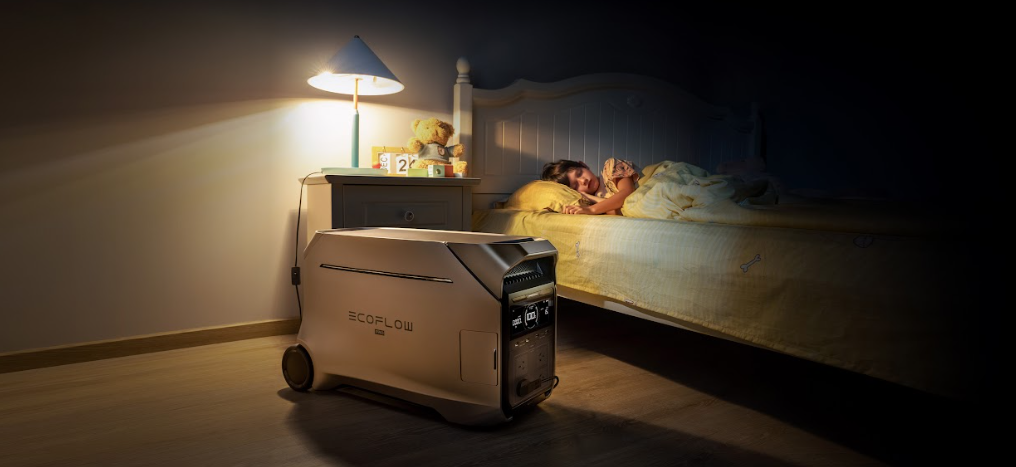 Portable power station in a softly lit bedroom with a child resting in bed.