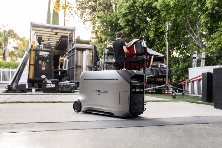 EcoFlow power station on a driveway with trees and a truck in the background