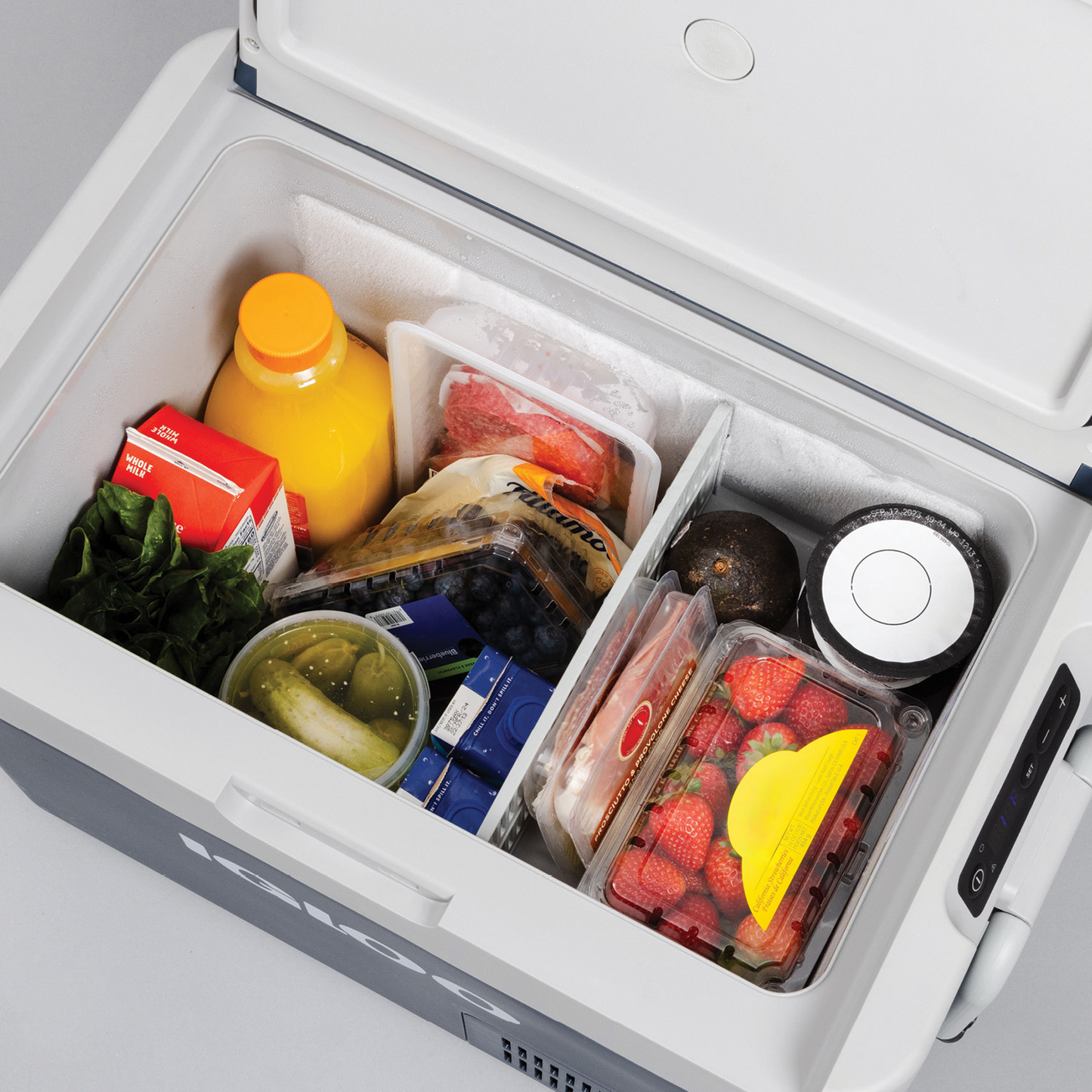 Igloo ICF18 portable fridge/freezer filled with fruits, vegetables, and beverages for convenient storage.