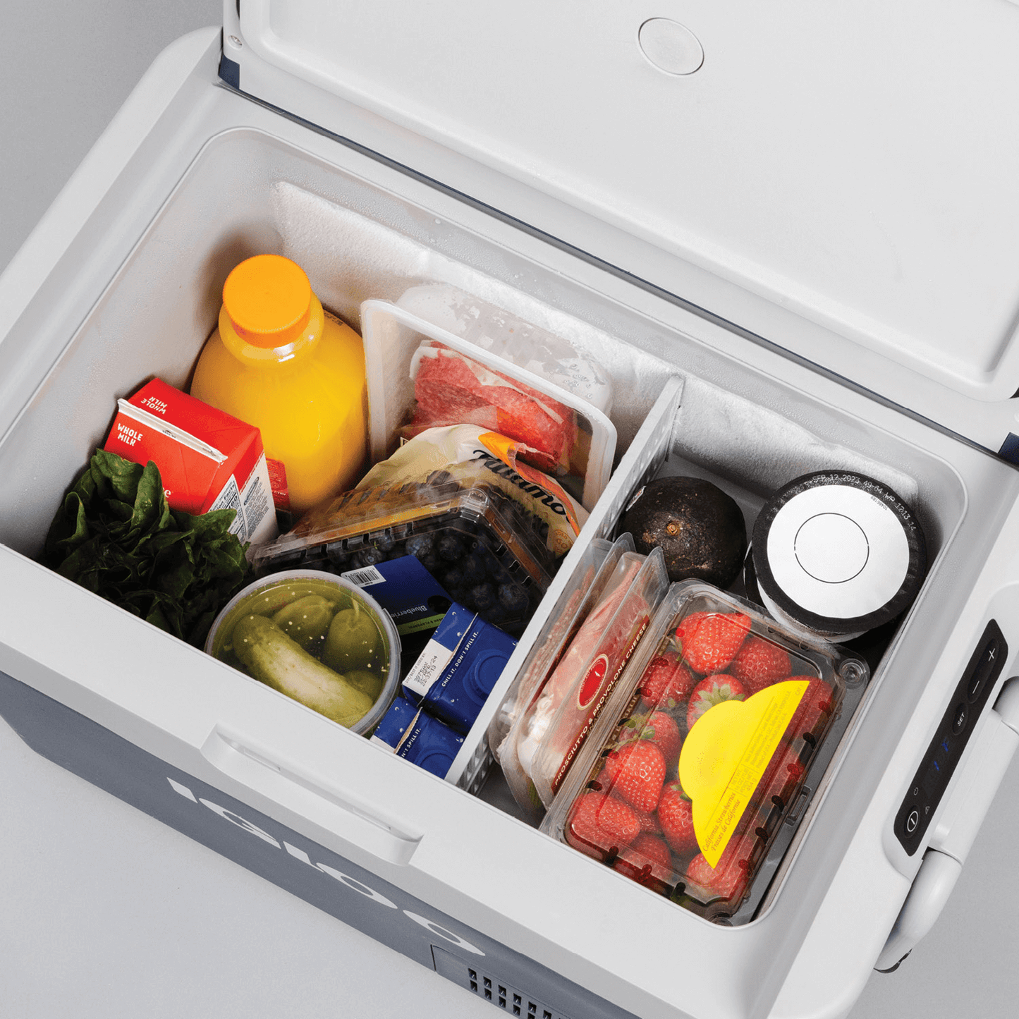Igloo ICF18 portable fridge/freezer filled with fruits, vegetables, and beverages for convenient storage.