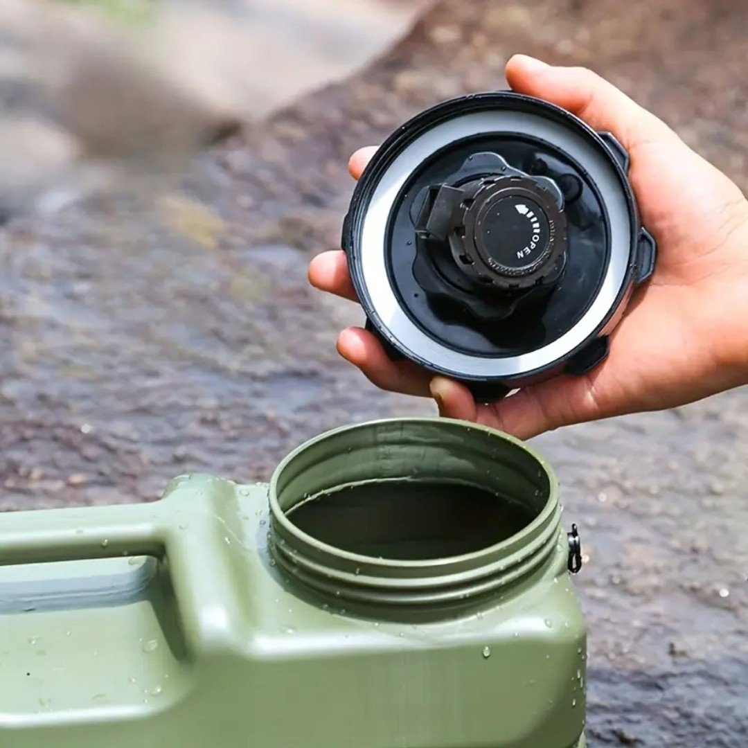 Person holding a black lid over a green water container with a blurred natural background