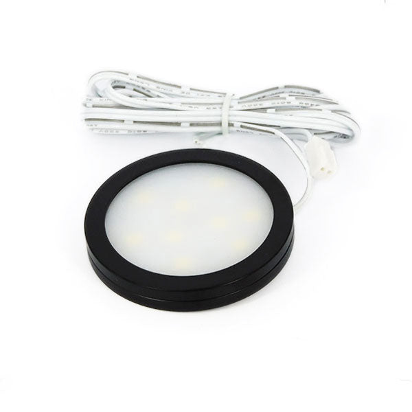 Circular light fixture with black rim and white bulb on a white background
