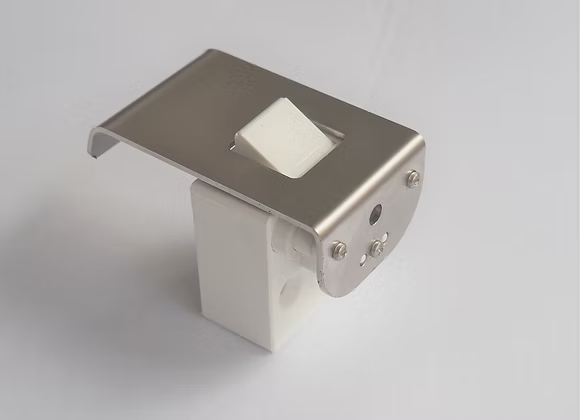 Metallic wall-mounted light fixture on a gray background