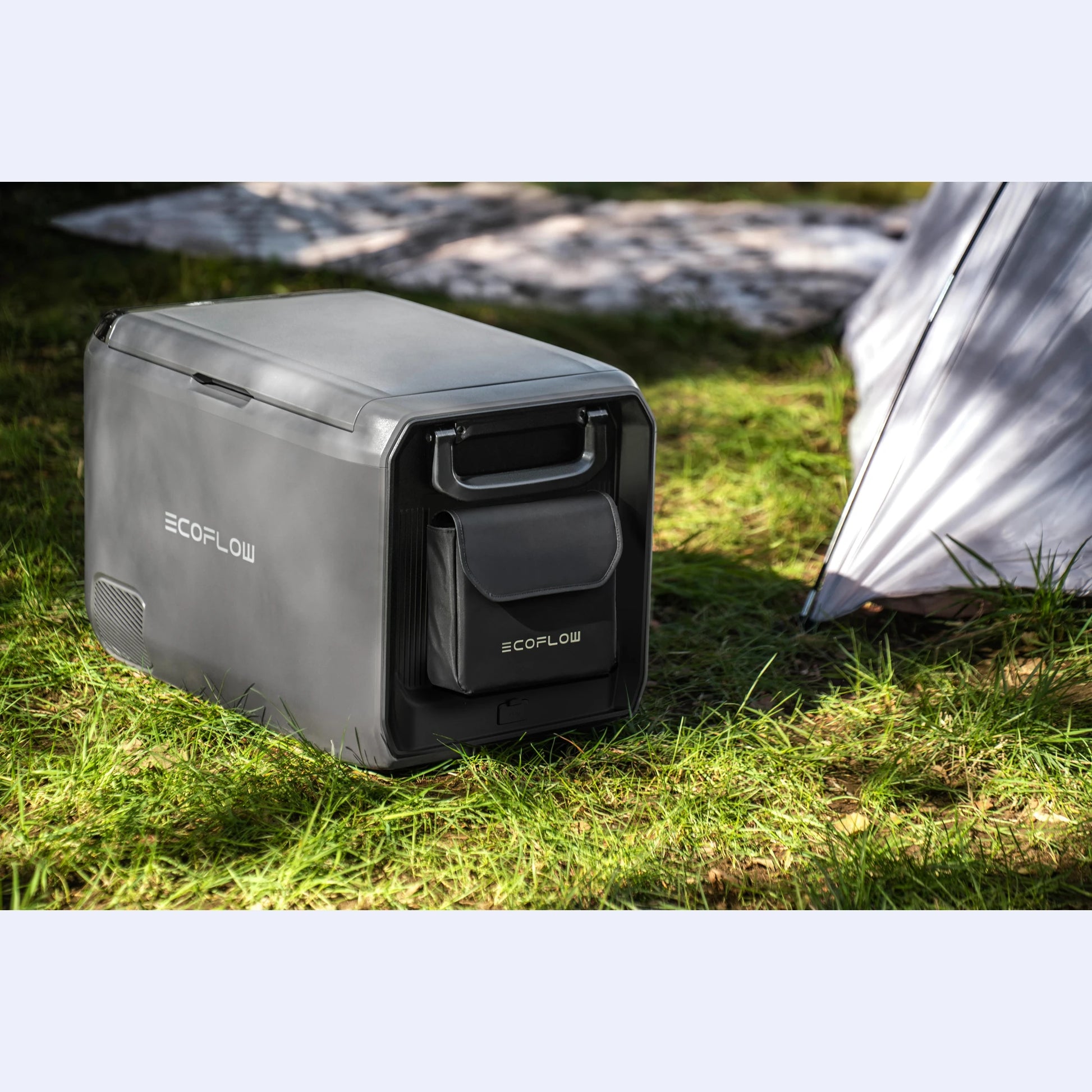 EcoFlow Glacier Portable Fridge Freezer on grass at campsite beside tent, compact 12V fridge for camping