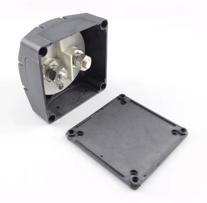 Black electrical junction box with metallic components on a white background

