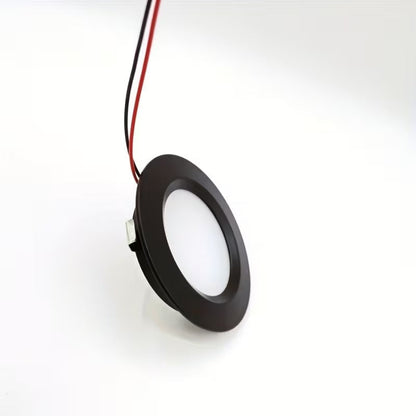 Round black LED light fixture on a white background