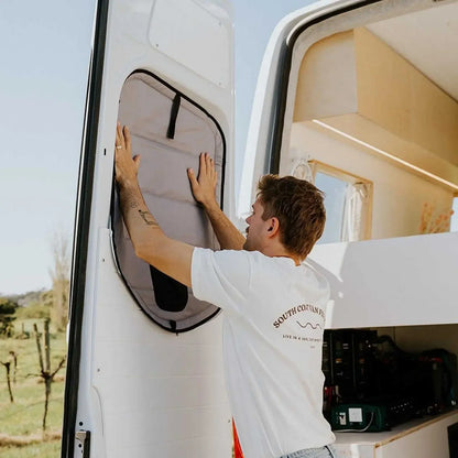 Person adjusting a Mercedes Sprinter half door plastic window cover. 