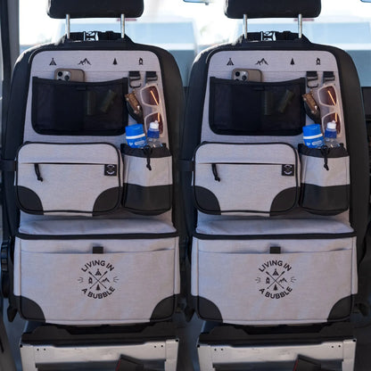 Car seat organizer with multiple pockets and water bottle holders on a vehicle's backseat.