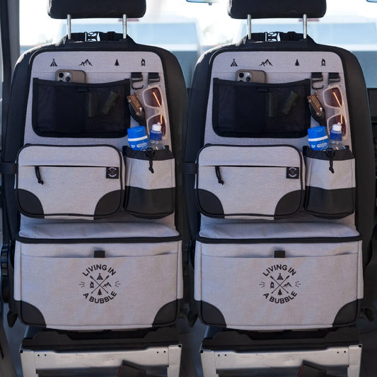 Car seat organizer with multiple pockets and water bottle holders on a vehicle's backseat.