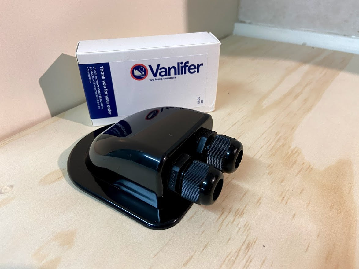A black double solar gland with the Vanlifer brand name on a cardboard box in the background.