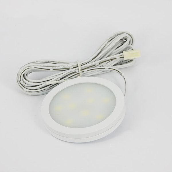 Round LED light with cable on a white background