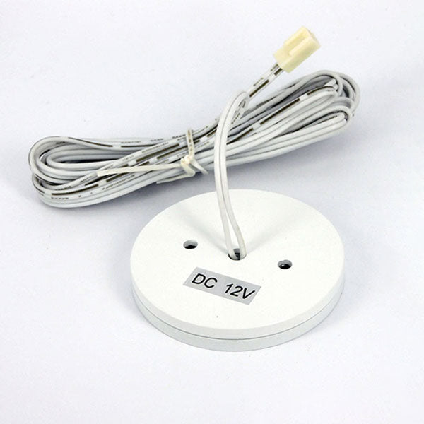 A white circular LED ceiling down light with DC 12V label on a white background