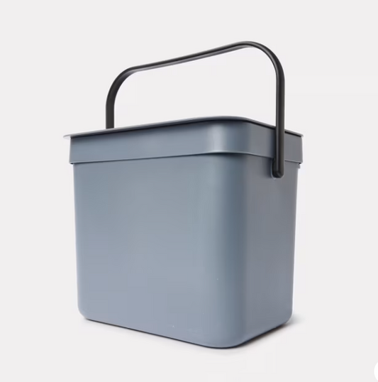 A gray rectangular fliptop rubbish bin with a handle.