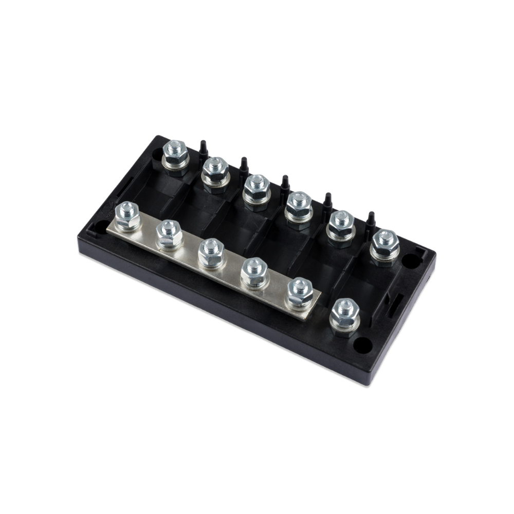 Black electrical terminal block with multiple screws on a white background