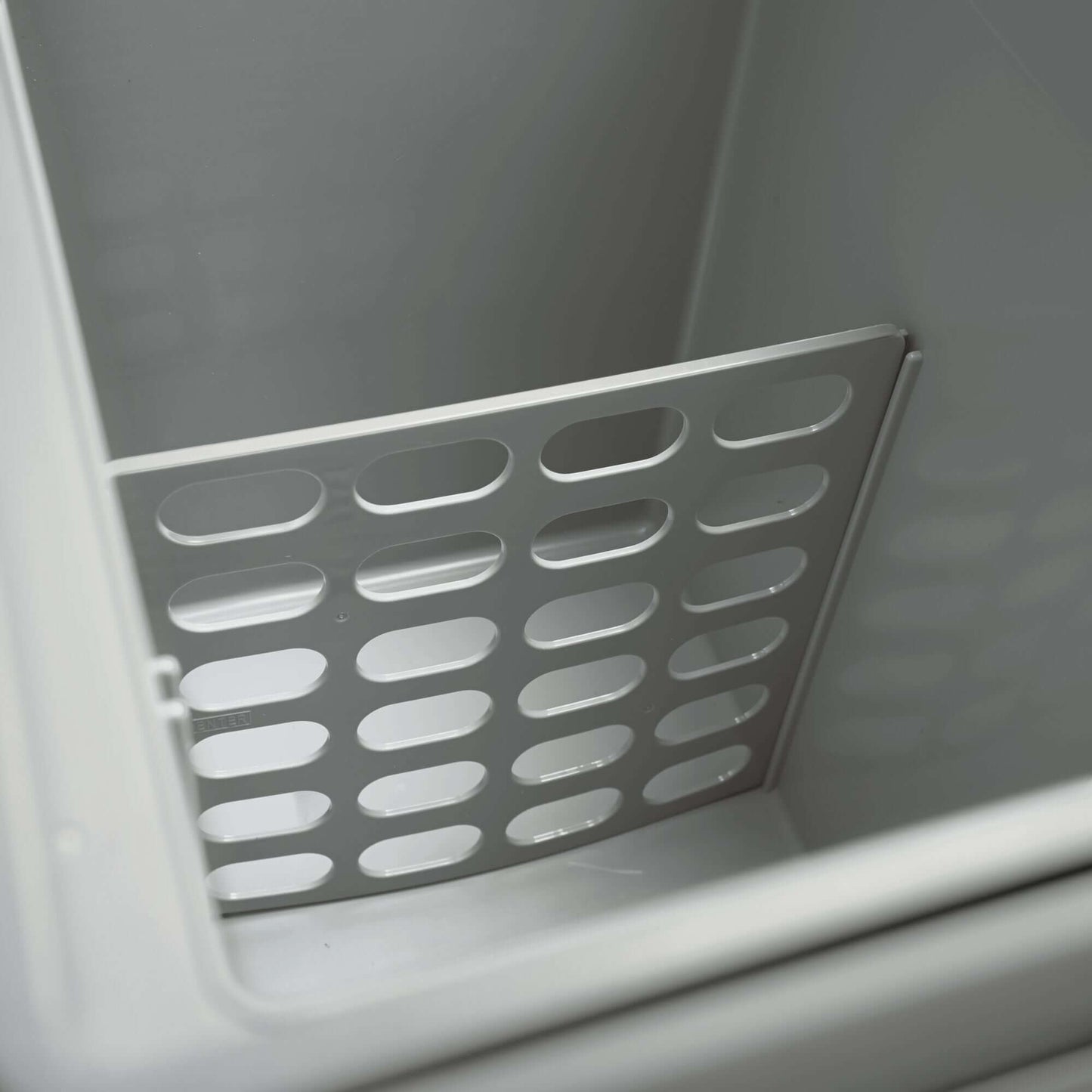 Interior of Dometic TCX 21 Portable Fridge showing the removable storage divider for efficient organization.