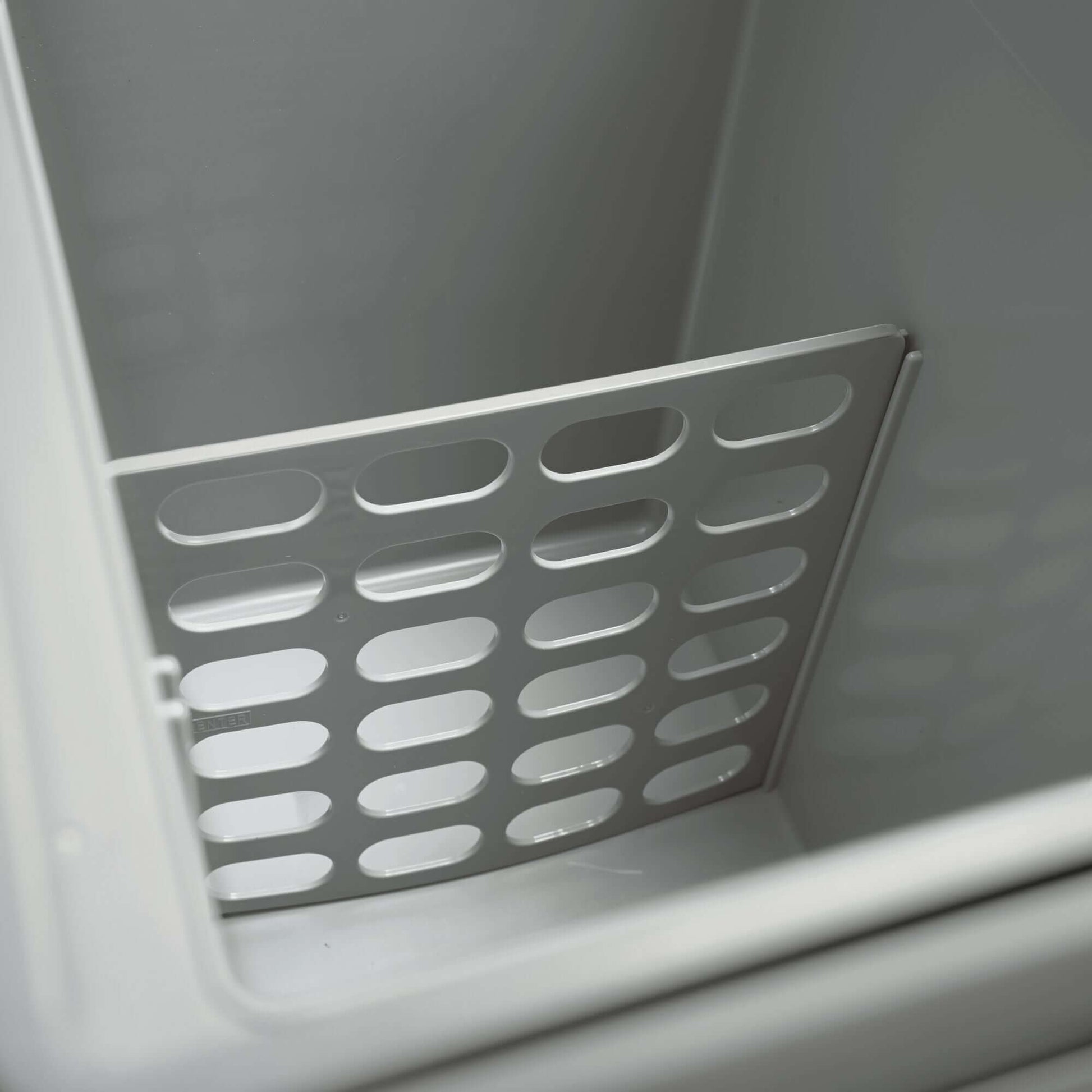 Interior of Dometic TCX 21 Portable Fridge showing the removable storage divider for efficient organization.