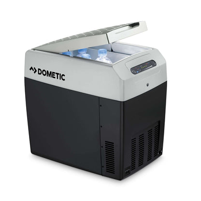 Dometic TCX 21 portable fridge with lid open, showcasing cool water bottles inside, ideal for camping and off-grid adventures.